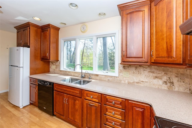 37 Lincoln Dr, Poughkeepsie, NY 12601 - kitchen featuring a sink, light wood-type flooring, backsplash, black dishwasher, and freestanding refrigerator