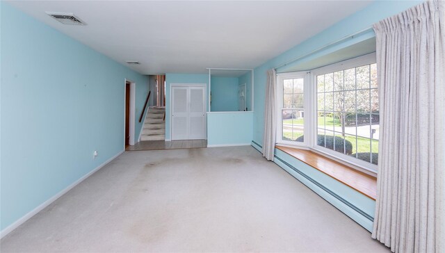 37 Lincoln Dr, Poughkeepsie, NY 12601 - unfurnished living room featuring visible vents, baseboard heating, baseboards, and a healthy amount of sunlight