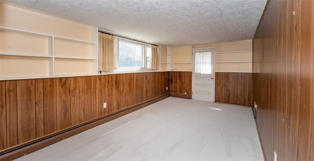 37 Lincoln Dr, Poughkeepsie, NY 12601 - empty room with wainscoting, a baseboard radiator, wooden walls, and carpet