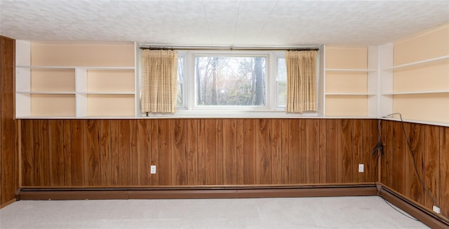 37 Lincoln Dr, Poughkeepsie, NY 12601 - unfurnished room featuring a baseboard radiator, carpet floors, and wooden walls