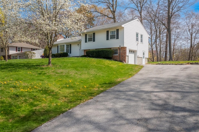 37 Lincoln Dr, Poughkeepsie, NY 12601 - tri-level home with aphalt driveway, a shingled roof, brick siding, a front yard, and a garage