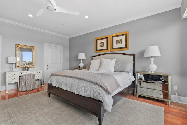 bedroom with ceiling fan, crown molding, wood finished floors, baseboards, and recessed lighting