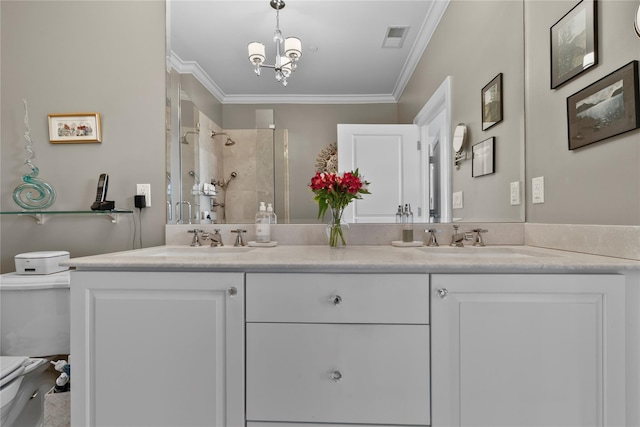 full bathroom with visible vents, crown molding, toilet, a shower stall, and a sink