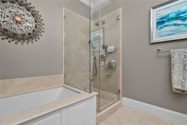 bathroom featuring baseboards, tile patterned flooring, a bath, and a stall shower