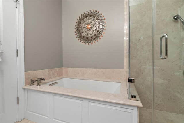 bathroom featuring a garden tub and a stall shower
