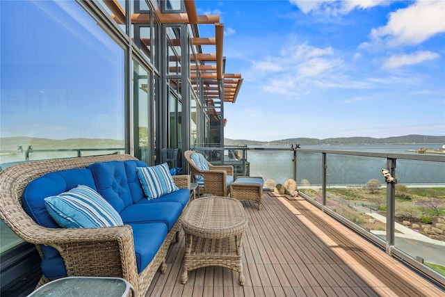 balcony featuring a water view and outdoor lounge area