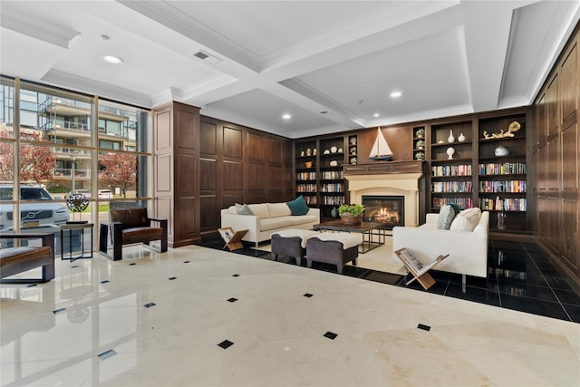 living area with visible vents, built in features, a glass covered fireplace, beamed ceiling, and coffered ceiling