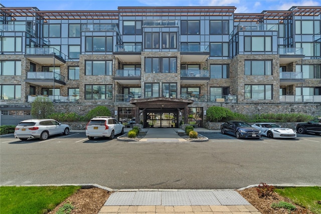 view of building exterior featuring uncovered parking