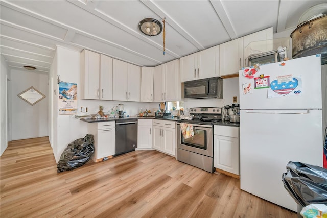 kitchen with white cabinetry, light wood finished floors, dark countertops, and stainless steel appliances