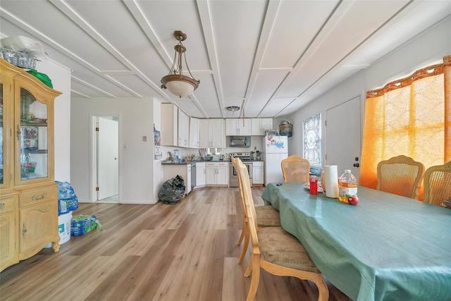 dining area with light wood-style flooring