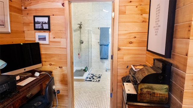 bathroom featuring wood walls and a stall shower