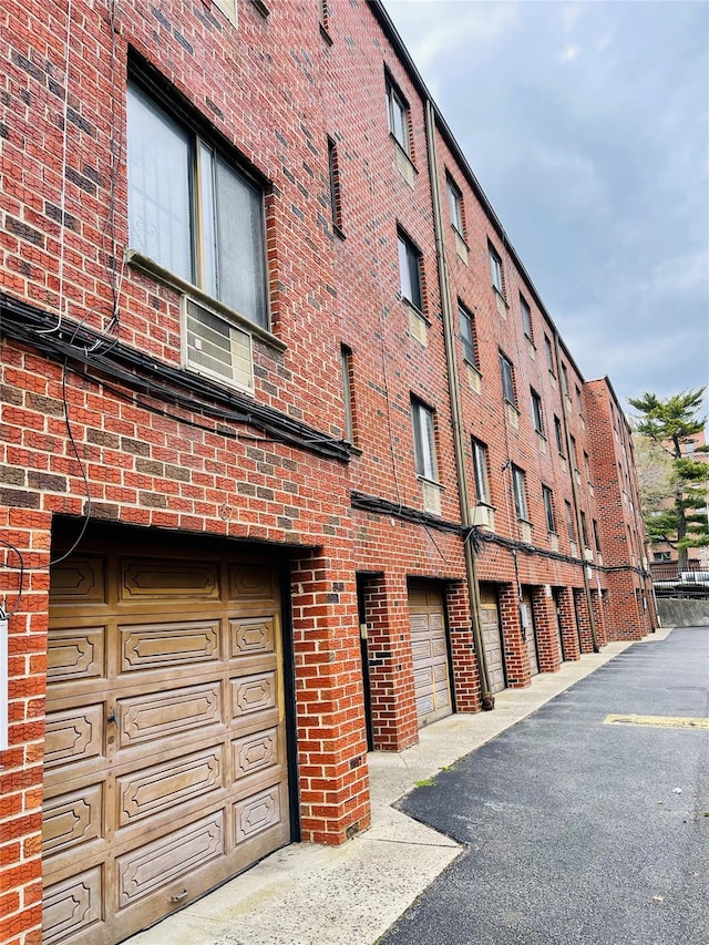 71-15 Sutton Pl Unit 3Fl, Fresh Meadows, NY 11365 - view of building exterior featuring a garage