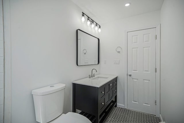 bathroom featuring toilet and vanity