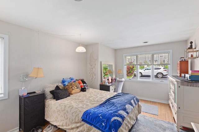 bedroom featuring baseboards and wood finished floors