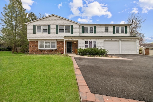 view of front of property featuring brick siding, a front lawn, driveway, and an attached garage