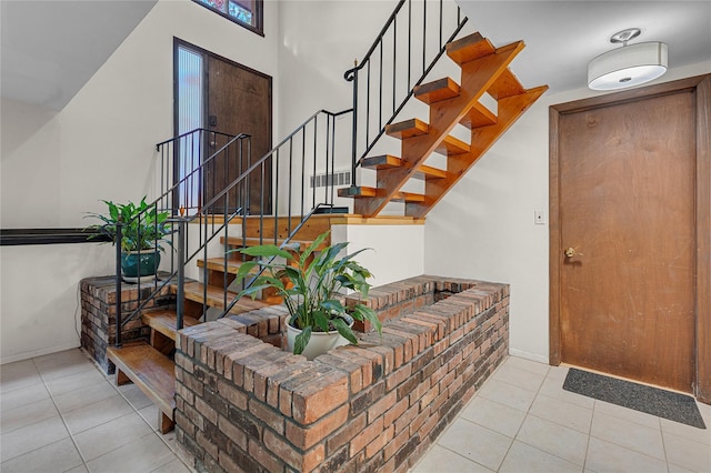 9 Salonga Woods Rd, Northport, NY 11768 - entryway featuring light tile patterned flooring, stairway, and baseboards