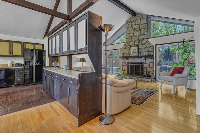 9 Salonga Woods Rd, Northport, NY 11768 - kitchen with black appliances, beam ceiling, light countertops, high vaulted ceiling, and healthy amount of natural light