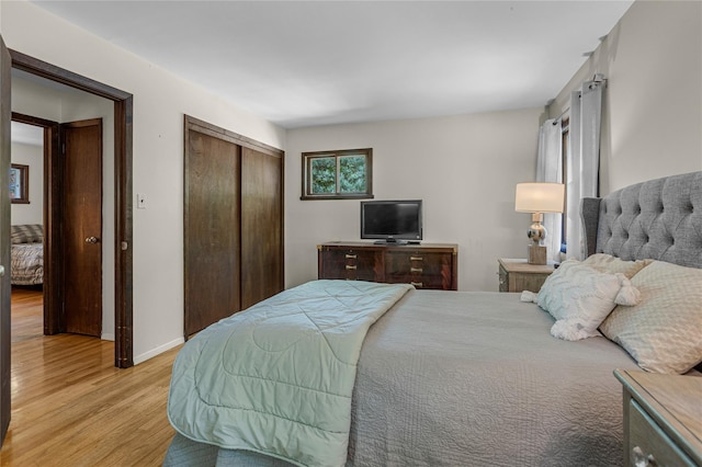 9 Salonga Woods Rd, Northport, NY 11768 - bedroom with light wood-style floors, a closet, and baseboards
