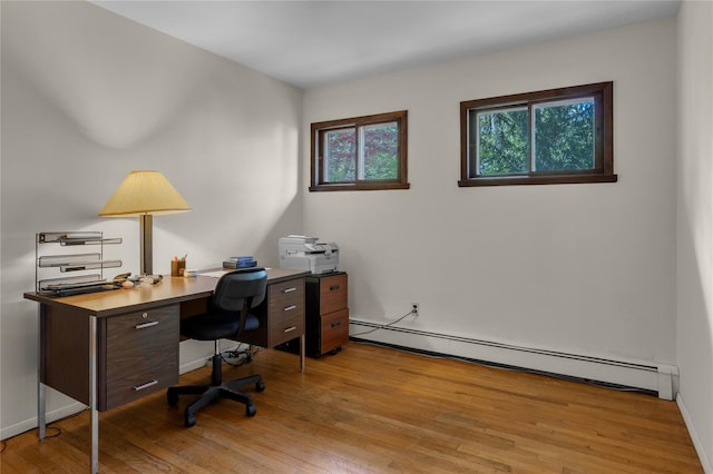 9 Salonga Woods Rd, Northport, NY 11768 - home office featuring baseboard heating, light wood-style flooring, and baseboards