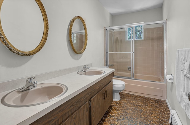9 Salonga Woods Rd, Northport, NY 11768 - bathroom featuring a baseboard heating unit, toilet, combined bath / shower with glass door, and double vanity