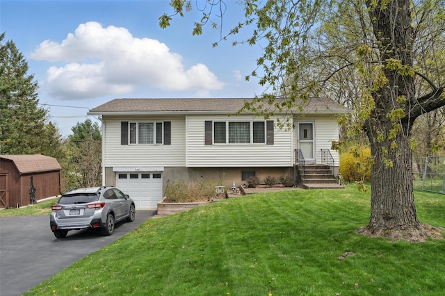 ranch-style home with fence, driveway, a front yard, and a garage