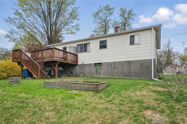 back of property with a lawn, a chimney, a deck, and stairway