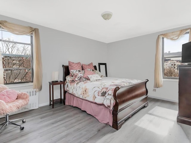270 N Broadway Unit 6H, Yonkers, NY 10701 - bedroom featuring baseboards, wood finished floors, and radiator