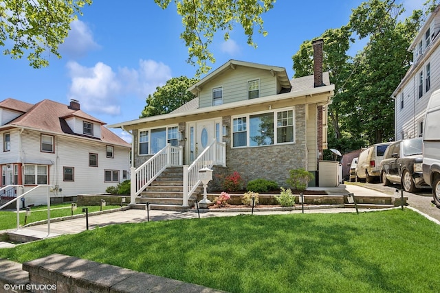 66 Vernon Ave, Mount Vernon, NY 10553 - view of front of house featuring a front yard, a chimney, and stone siding