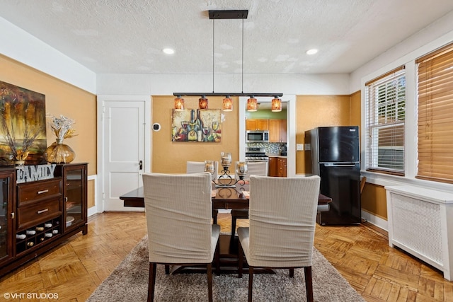 66 Vernon Ave, Mount Vernon, NY 10553 - dining space with radiator, recessed lighting, a textured ceiling, and baseboards