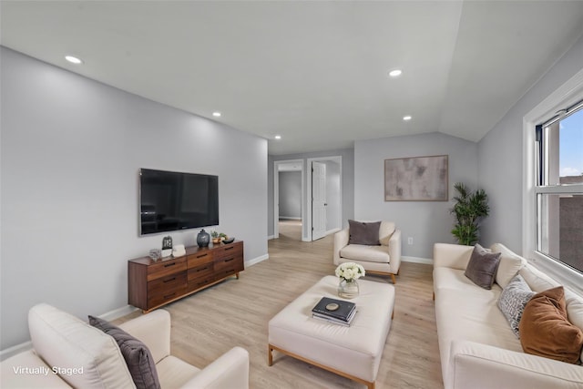 living area featuring recessed lighting, light wood-style floors, lofted ceiling, and baseboards