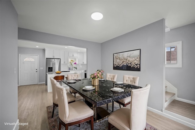 dining space featuring recessed lighting, stairway, light wood-style flooring, and baseboards
