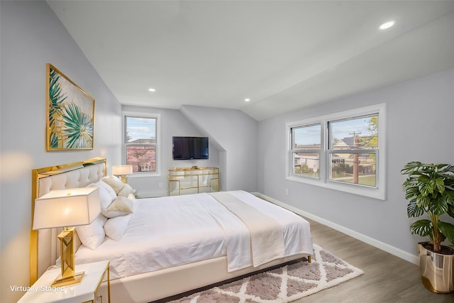 bedroom with baseboards, recessed lighting, wood finished floors, and lofted ceiling