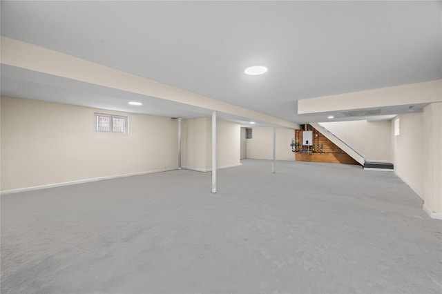 below grade area featuring stairway, recessed lighting, and baseboards