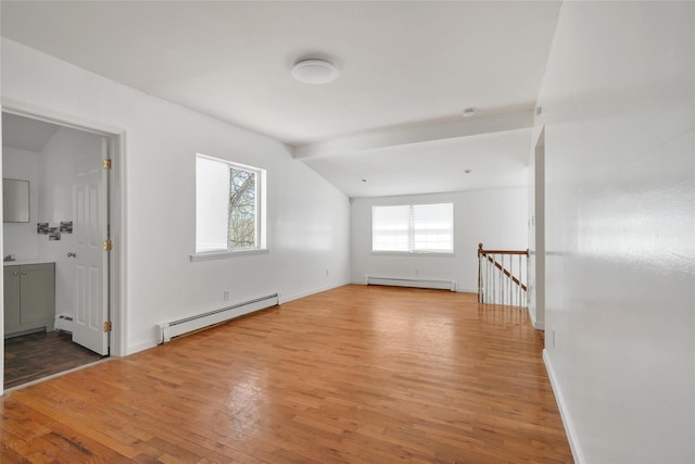 interior space featuring baseboards, a baseboard radiator, light wood finished floors, and a baseboard heating unit