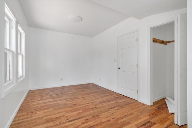 unfurnished bedroom featuring baseboards and light wood-type flooring