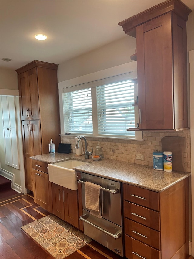 20815 38th Ave, Bayside, NY 11361 - kitchen featuring dishwasher, backsplash, dark wood-type flooring, a sink, and light stone counters