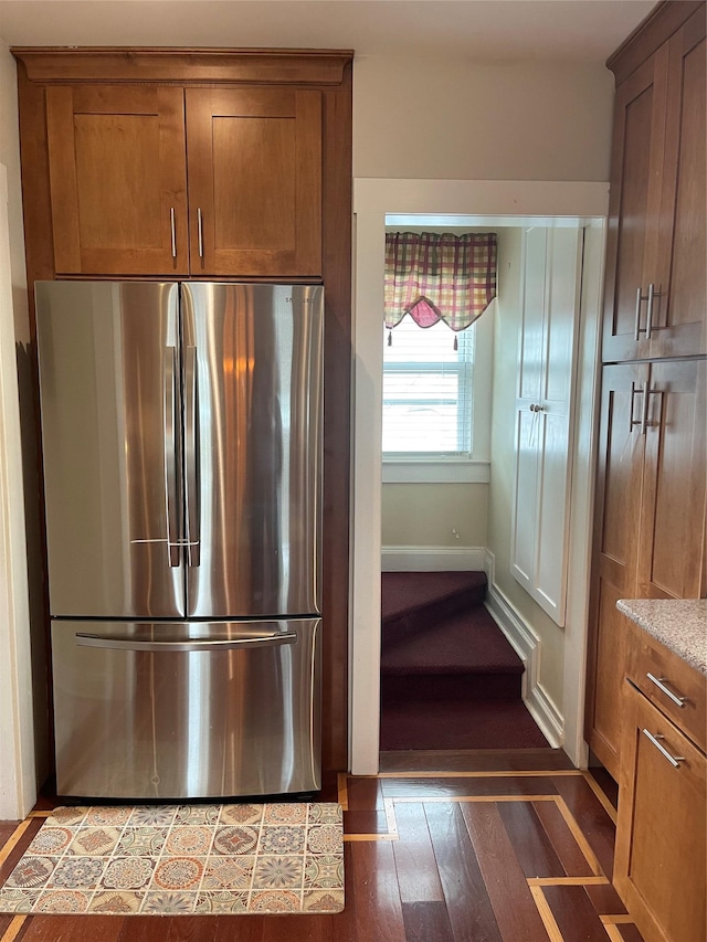 20815 38th Ave, Bayside, NY 11361 - kitchen with freestanding refrigerator, brown cabinetry, light stone countertops, and light wood-style flooring