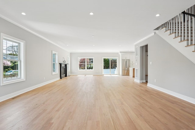 44 Harbor Hills Dr, Port Washington, NY 11050 - unfurnished living room with crown molding, baseboards, and a healthy amount of sunlight