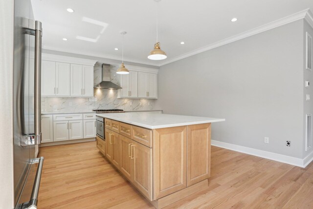 44 Harbor Hills Dr, Port Washington, NY 11050 - kitchen featuring wall chimney range hood, tasteful backsplash, appliances with stainless steel finishes, a center island, and light wood-type flooring