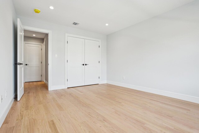 44 Harbor Hills Dr, Port Washington, NY 11050 - unfurnished bedroom featuring visible vents, a closet, baseboards, light wood-type flooring, and recessed lighting