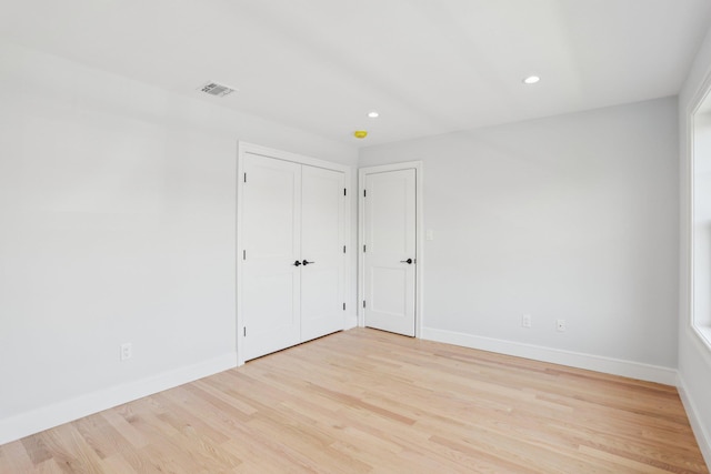 44 Harbor Hills Dr, Port Washington, NY 11050 - unfurnished bedroom with light wood-type flooring, recessed lighting, visible vents, and baseboards