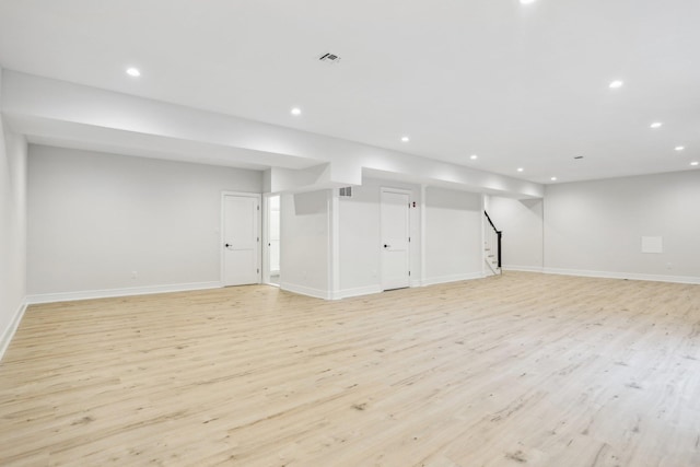 44 Harbor Hills Dr, Port Washington, NY 11050 - finished basement with recessed lighting, stairs, and light wood-style floors