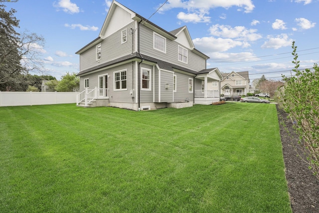 44 Harbor Hills Dr, Port Washington, NY 11050 - back of house with a lawn and fence