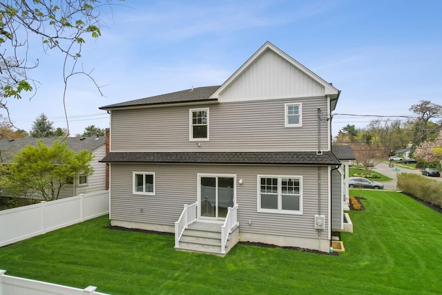 44 Harbor Hills Dr, Port Washington, NY 11050 - back of house featuring fence, a yard, entry steps, and a shingled roof