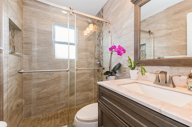 186 Stuart Rd, Valley Stream, NY 11581 - bathroom with a shower stall, tile walls, toilet, and vanity