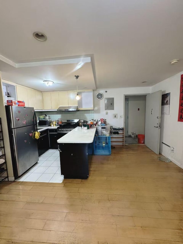 132-03 Sanford Ave Unit 2F, Flushing, NY 11355 - kitchen with appliances with stainless steel finishes, a peninsula, light wood finished floors, under cabinet range hood, and electric panel
