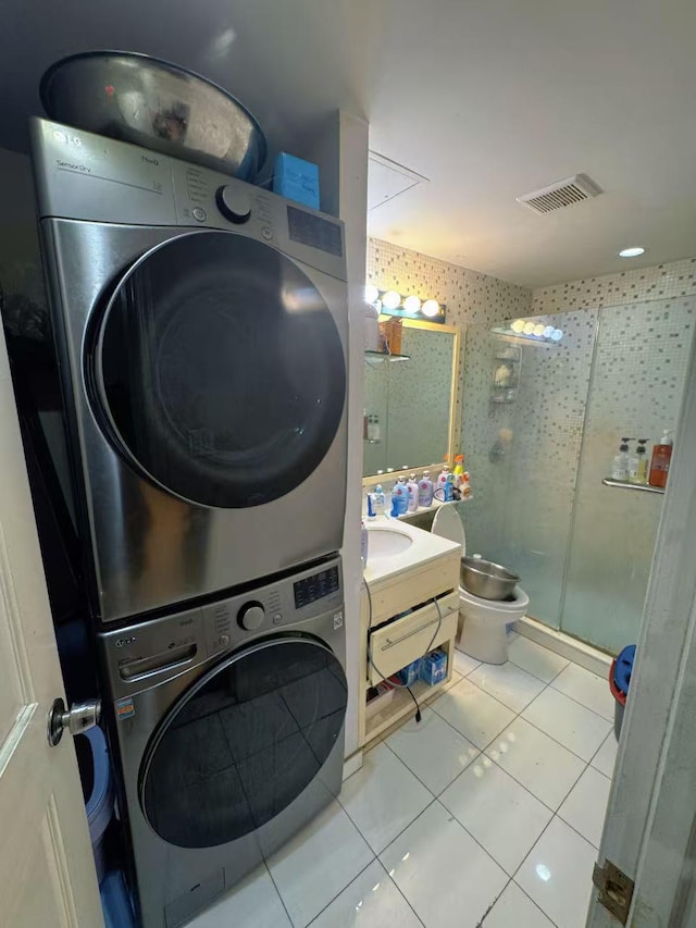 132-03 Sanford Ave Unit 2F, Flushing, NY 11355 - laundry area with stacked washer / dryer and tile patterned flooring