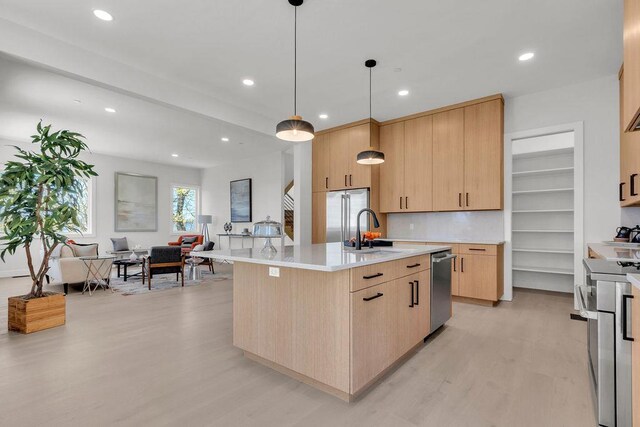123 N Riverside Ave, Croton-On-Hudson, NY 10520 - kitchen with light wood-style flooring, light brown cabinetry, stainless steel appliances, and a sink