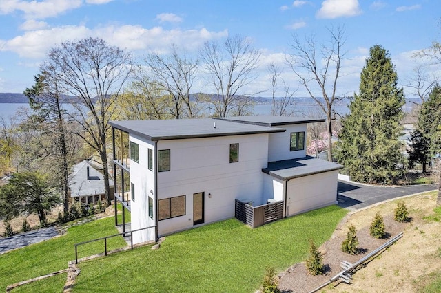 123 N Riverside Ave, Croton-On-Hudson, NY 10520 - rear view of property with a lawn, an attached garage, fence, and stucco siding