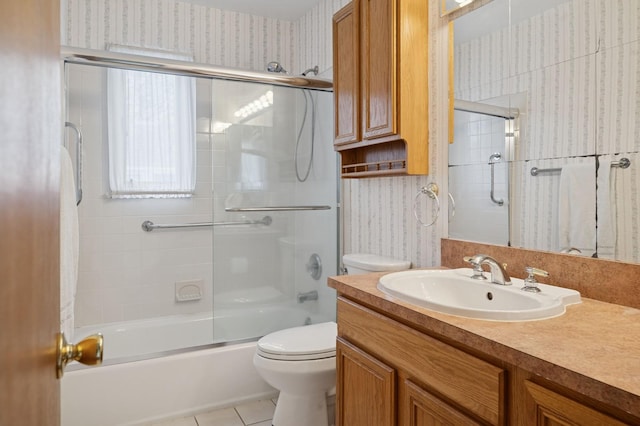 full bath with vanity, toilet, wallpapered walls, and shower / bath combination with glass door